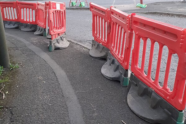 Alternative pedestrian route through gap in barriers